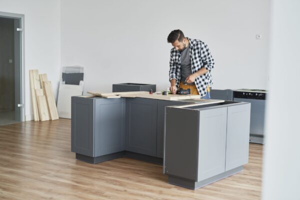 carpenter installing new kitchen furniture