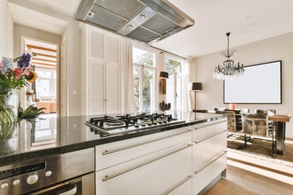 comfortable kitchen with white kitchen unit and marble countertop